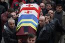 Georgian men carry a casket with the body of Thomas Sukhiashvili, a Georgian national who was killed in fighting against Russian-backed separatists in eastern Ukraine, during a funeral ceremony in Tbilisi, Georgia, Thursday, Jan. 22, 2015. (AP Photo/Shakh Aivazov)