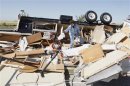 Mikie Hooper of Tuttle, Oklahoma, collects her belongings from her RV which was destroyed by a tornado in El Reno