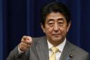 Japan's Prime Minister Shinzo Abe points to a reporter during a news conference at his official residence in Tokyo