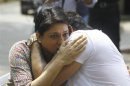 Bollywood actor Sanjay Dutt embraces his sister Priya Dutt after breaking down during a news conference outside his residence in Mumbai