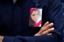 A male relative of Anni Dewani, a Swedish woman of Indian origin who was murdered while on honeymoon in South Africa, displays her photo on his jacket at Westminster Crown Court in London on July 24, 2013