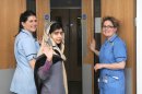 This photo made available by Queen Elizabeth Hospital, Birmingham, England shows Malala Yousufzai saying goodbye as she is discharged from the hospital to continue her rehabilitation at her family's temporary home in the area, Friday, Jan. 4, 2013. the teenage Pakistani girl shot in the head by the Taliban for promoting girls' education has been released from the hospital after impressing doctors with her strength. Queen Elizabeth Hospital Birmingham officials said Friday 15-year-old Malala Yousufzai will be treated as an outpatient before being readmitted for further cranial re-constructive surgery at the end of the month or in early February. (AP Photo/Queen Elizabeth Hospital Birmingham)