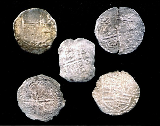 Handout photo of five Mexico City and Peruvian silver coins recovered from the Tortugas shipwreck, in the Straits of Florida