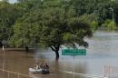 Rescue personnel search the floodwaters along Brays Bayou in southwest Houston