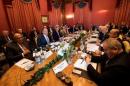 Foreign ministers meet around a table during a bilateral meeting where they discussed the crisis in Syria, in Lausanne