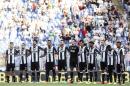 Juventus' players observe a minute of silence to honor the victims of Wednesday's earthquake that hit central Italy, prior to a Serie A soccer match between Lazio and Juventus at Rome's Olympic stadium, Saturday, Aug. 27, 2016. (Angelo Carconi/ANSA via AP)