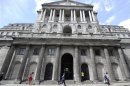 People walk and jog past the Bank of England
