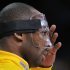 Los Angeles Lakers guard Kobe Bryant adjusts his protective mask prior to the Lakers' NBA basketball game against the Minnesota Timberwolves, Wednesday, Feb. 29, 2012, in Los Angeles. Bryant broke his nose during the All-Star game. (AP Photo/Mark J. Terrill)