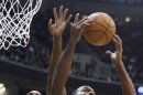 Miami Heat center Bosh and Utah Jazz forward Millsap battle for a rebound during the first half of their NBA basketball game in Salt Lake City, Utah