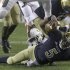Notre Dame quarterback Everett Golson (5) scrambles to the one yard line and is tackled by Miami linebacker Eddie Johnson during the first half of an NCAA college football game at Soldier Field Saturday, Oct. 6, 2012, in Chicago.(AP Photo/Charles Rex Arbogast)