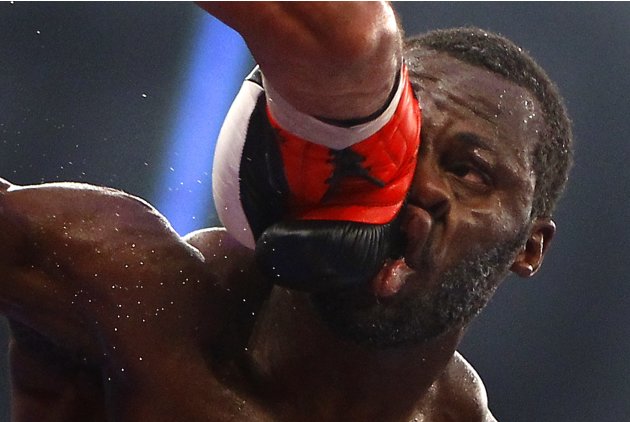 Challenger Cunningham of the U.S. takes a heavy punch from Hernandez of Cuba during their IBF cruiserweight World Championship title re-match in Frankfurt