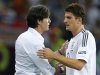 Germany's Gomez shakes hands with his coach Loew during their Group B Euro 2012 soccer match against Netherlands in Kharkiv