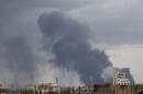 Smoke billows after an air strike hit the international airport of Yemen's capital Sanaa