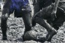FILE - This July 8, 2007 file photo shows people playing soccer in the mud of the Elbe River near Brunsbuettel, some ten kilometers off the North Sea, northern Germany. Soccer is falling under a cloud of suspicion as never before, sullied by a multibillion-dollar web of match-fixing that is staining increasingly larger parts of the world's most popular sport. (AP Photo/Heribert Proepper, file)