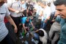Injured people get first aid after an explosion during an election rally of pro-Kurdish Peoples' Democratic Party (HDP) in Diyarbakir, Turkey