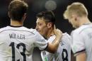 Germany's Mesut Ozil celebrates after scoring his side's second goal in extra time with teammate Thomas Mueller during the World Cup round of 16 soccer match between Germany and Algeria at the Estadio Beira-Rio in Porto Alegre, Brazil, Monday, June 30, 2014. Germany defeated Algeria 2-1 to advance to the quarterfinals. (AP Photo/Matthias Schrader)