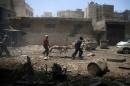 Men transport a casualty at a site hit by airstrikes in the rebel held Douma neighbourhood of Damascus