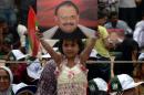A young girl from Pakistan's Muttahida Qaumi Movement (MQM) party holds a photograph of party leader Altaf Hussain during a sit-in protest calling for Hussain's release in Karachi on June 6, 2014