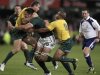 South Africa's Spies is tackled by Australia's Cooper and Genia during their Tri-Nations rugby union match in Durban