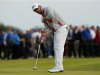 Adam Scott of Australia watches his putt on the 14th green during the third round of the British Open golf championship at Royal Lytham & St Annes
