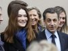 French President and UMP candidate Nicolas Sarkozy and his wife Carla Bruni-Sarkozy leave after casting their votes in the first round of French presidential elections in Paris, France, Sunday, April 22, 2012. (AP Photo/Remy de la Mauviniere)