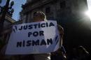 A woman holds a sign during a demonstration outside Argentina's Congress in Buenos Aires