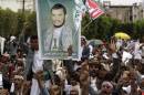 Supporters of the Shi'ite Houthi attend hold a poster of the group's leader Abdul-Malik al-Houthi during an anti-government rally in Sanaa