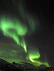 An Aurora borealis is pictured near the city of Tromsoe, northern Norway. Solar radiation from a massive sun storm -- the largest in nearly a decade -- collided with the Earth's atmosphere on Tuesday, prompting an airline to reroute flights and skywatchers to seek out spectacular light displays. (AFP Photo/Rune Stoltz Bertinussen)
