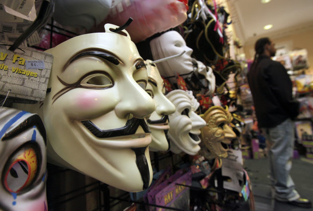 FILE - In this Oct. 21, 2011 file photo, masks, including "V for Vendetta," left, are displayed at a Ricky's Halloween store in New York. Television audiences across China watched an anarchist antihero rebel against a totalitarian government and persuade the people to rule themselves. Soon the Internet was crackling with quotes of “V for Vendetta’s” famous line: “People should not be afraid of their governments. Governments should be afraid of their people.” The airing of the movie Friday night, Dec. 14, 2012 on China Central Television stunned viewers and raised hopes that China is loosening censorship. (AP Photo/Richard Drew, File)