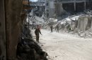 Syrian government forces patrol the Khalidiyah district of Syria's central city of Homs on July 31, 2013