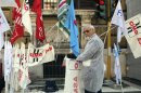 A doctor unfurls a flag during a protest in front of the Economy Ministry in Rome