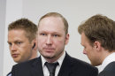Defendant Anders Behring Breivik seen talking to one of his lawyers, Tord Jordet, right, during the fourth day of proceedings in the courthouse in Oslo, Norway, Thursday April 19, 2012. Confessed mass killer Anders Behring Breivik testified Thursday that he had planned to capture and decapitate former Norwegian Prime Minister Gro Harlem Brundtland during his shooting massacre on Utoya island. (AP Photo / Erlend Aas)
