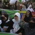 Pakistani Shiite Muslim women chant anti U.S. slogans during a demonstration that is part of widespread anger across the Muslim world about a film ridiculing Islam's Prophet Muhammad, Sunday, Sept. 23, 2012 in Lahore, Pakistan. The woman, center, wear a banner that reads, “at your service Hussein.” (AP Photo/K.M. Chaudary)