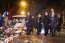 US President Barack Obama (R) pays his respects with French President Francois Hollande (2nd R) and Paris Mayor Anne Hidalgo (3rd R) at a memorial outside the Bataclan in Paris , France, November 30, 2015