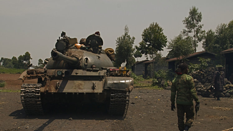 A Congolese government tank prepares to deploy for fighting against M23 rebels, at an operating base in Kanyaruchinya, north of Goma, eastern Congo, Friday, Aug. 23, 2013. Congo's government accused Rwanda on Friday of supporting a rebel attack on Goma after mortar rounds killed a mother and her three children and damaged a church in the eastern Congo border city. (AP Photo/Joseph Kay)