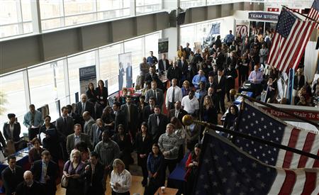 Job applicants listen to a presentation prior to the opening of a job fair for veterans and their spouses held by the U.S. Chamber of Commerce and the Washington Nationals baseball club at Nationals Park in Washington December 5, 2012. REUTERS/Gary Cameron