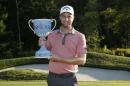Chris Kirk holds the trophy after winning the Deutsche Bank Championship golf tournament in Norton, Mass., Monday, Sept. 1, 2014. (AP Photo/Michael Dwyer)