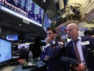 Specialist trader Joseph Dreyer of Knight Capital works at the post that trades Carnival Cruise lines on the floor of the New York Stock Exchange