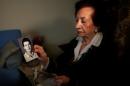 In this Thursday April 10, 2014 photo, Lebanese Mary Mansourati, 82, whose son Dani went missing in Syria in 1992 at the age of 30, show his portrait during an interview with the Associated Press at her house, in Beirut, Lebanon. Dani is among an estimated 17,000 Lebanese still missing from the time of Lebanon's civil war or the years of Syrian domination that followed. Syria's civil war has added new urgency to the plight of their families, many of whom are convinced their loved ones are still alive and held in Syrian prisons, at risk of being lost or killed in the country's mayhem. (AP Photo/Hussein Malla)