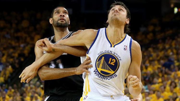 Andrew Bogut (R) of the Golden State Warriors fights for position against Tim Duncan of the San Antonio Spurs, during the NBA Playoffs, at the Oracle Arena in Oakland, California, on May 16, 2013