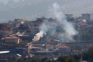 Smoke rises as workers burn stalks of cannabis in Lazarat, …