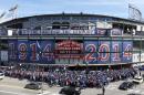 Baseball fans wait to enter Wrigley Field on the 100th anniversary of the first baseball game at the ballpark, before a game between the Arizona Diamondbacks and Chicago Cubs, Wednesday, April 23, 2014, in Chicago. (AP Photo/Charles Rex Arbogast)