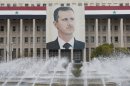 The picture of the Syria's President Bashar al-Assad is seen on central bank building in Damascus