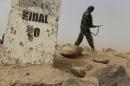 A Malian soldier patrols on a road between Gao and Kidal in northern Mali on July 26, 2013