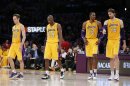 Lakers starters walk onto the court after a timeout during their loss to the Dallas Mavericks in their NBA basketball game in Los Angeles