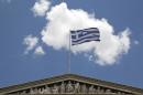 The Greek flag flies at the top of the Athens Academy building, on Thursday, June 4, 2015 .Greece remains at loggerheads with creditors over key economic reforms after a meeting between Prime Minister Alexis Tsipras and the head of the European Union's executive arm failed to yield a breakthrough on the release of vital bailout loans.(AP Photo/Petros Giannakouris)