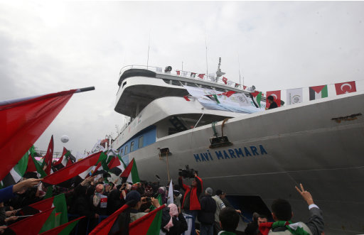 FILE - In this Sunday, Dec. 26, 2010 file photo, people holding Turkish and Palestinian flags cheer as the Mavi Marmara ship, the lead boat of a flotilla headed to the Gaza Strip which was stormed by Israeli naval commandos in a predawn confrontation in the Mediterranean on May 31, 2010, arrives back in Istanbul, Turkey. Turkey said Friday Sept. 2, 2011 it was expelling the Israeli ambassador and cutting military ties with Israel over the last year's deadly raid on a Gaza-bound aid flotilla, further souring the key Mideast relationship between Turkey and Israel.(AP Photo/Burhan Ozbilici, File)