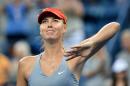 Maria Sharapova of Russia waves to the crowd after defeating Alexandra Dulgheru of Romania during their 2014 US Open women's singles match on August 27, 2014 in New York