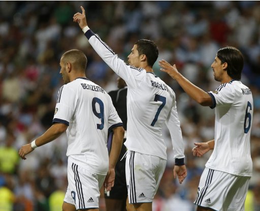 Real Madrid's Cristiano Ronaldo celebrates after scoring a goal against Granada with teammates Karim Benzema and Sami Khedira during their Spanish first division soccer match at the Santiago Bernabeu stadium in Madrid
