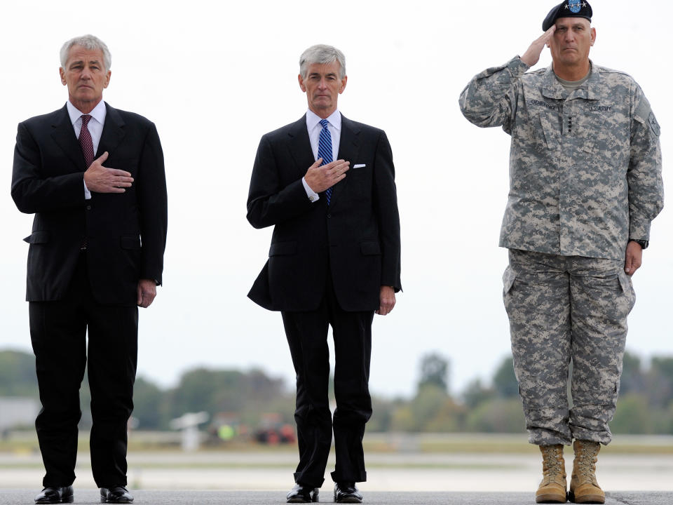 From left, Defense Secretary Chuck Hagel, Army Secretary John McHugh and Army Chief of Staff Gen. Raymond T. Odierno watch the remains of Pfc. Cody J. Patterson, not pictured, get carried off a military plane at Dover Air Force Base, Del. Wednesday, Oct. 9, 2013. According to the Department of Defense, Patterson, 24, of Philomath, Ore., died Oct. 6, 2013 in Zhari district, Afghanistan of injuries sustained when enemy forces attacked his unit with an improvised explosive device. (AP Photo/Steve Ruark)